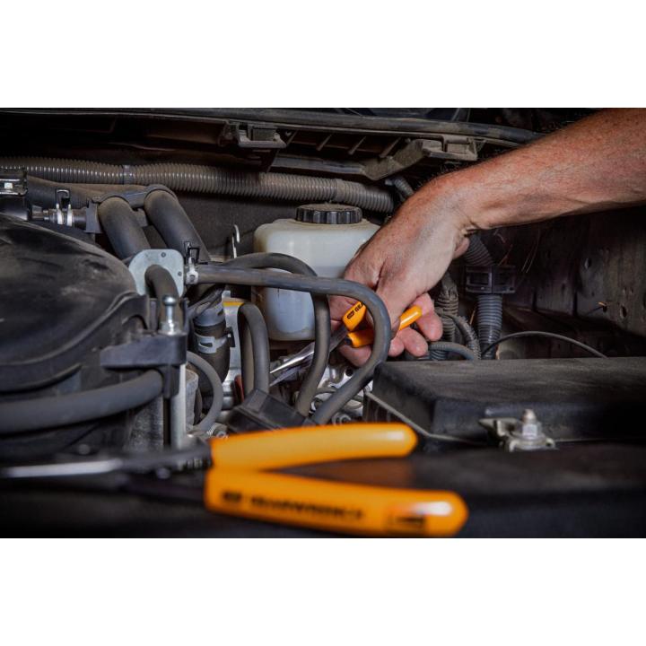 A hand using GEARWRENCH 89730 5 piece mini plier set to work on a car engine, focusing on precision and detail in his task