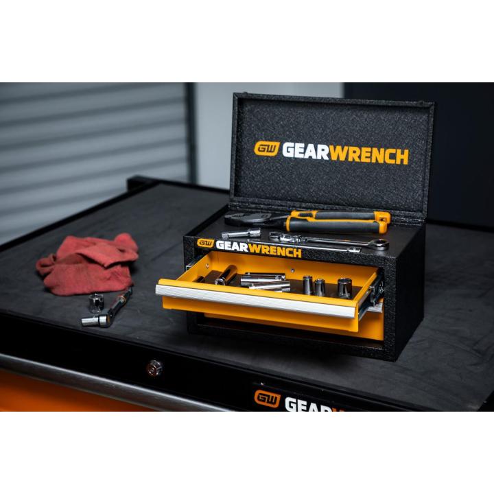 Image of the GWBXMINIS on top of a tool cabinet with its lid and drawers open showing tools inside of it