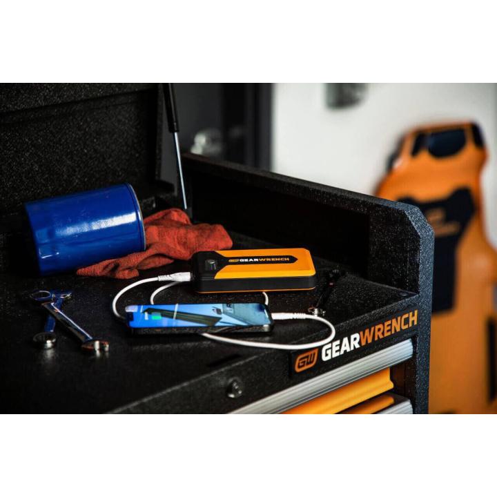 GEARWRENCH GWLBJ12 battery jumper and power bank sitting in the top of a GEARWRENCH top chest charging a smartphone