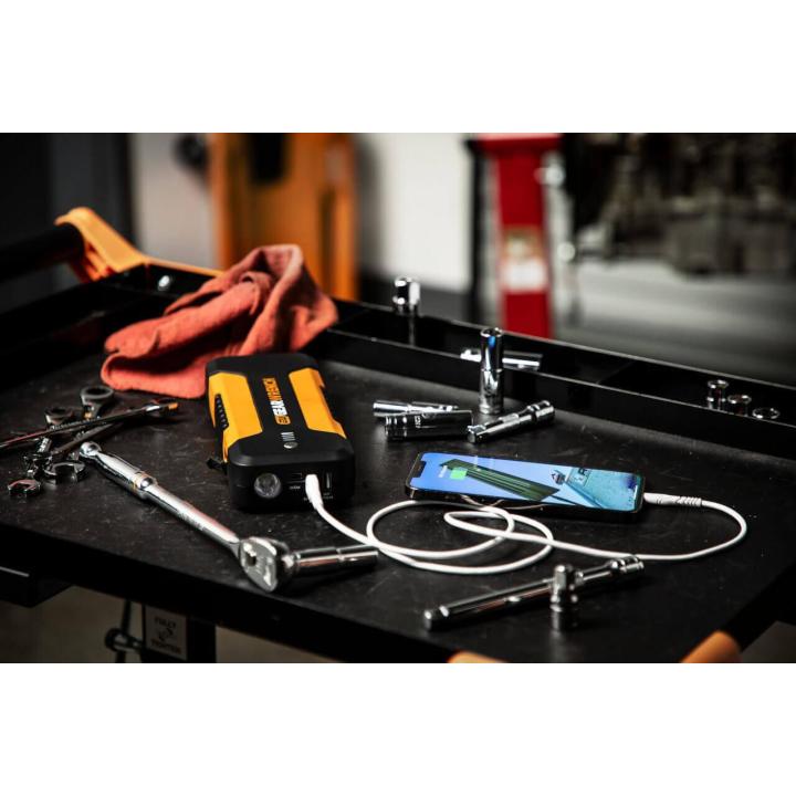 GEARWRENCH GWLBJ20 battery jumper and power bank sitting on top of a work cart charging a smartphone